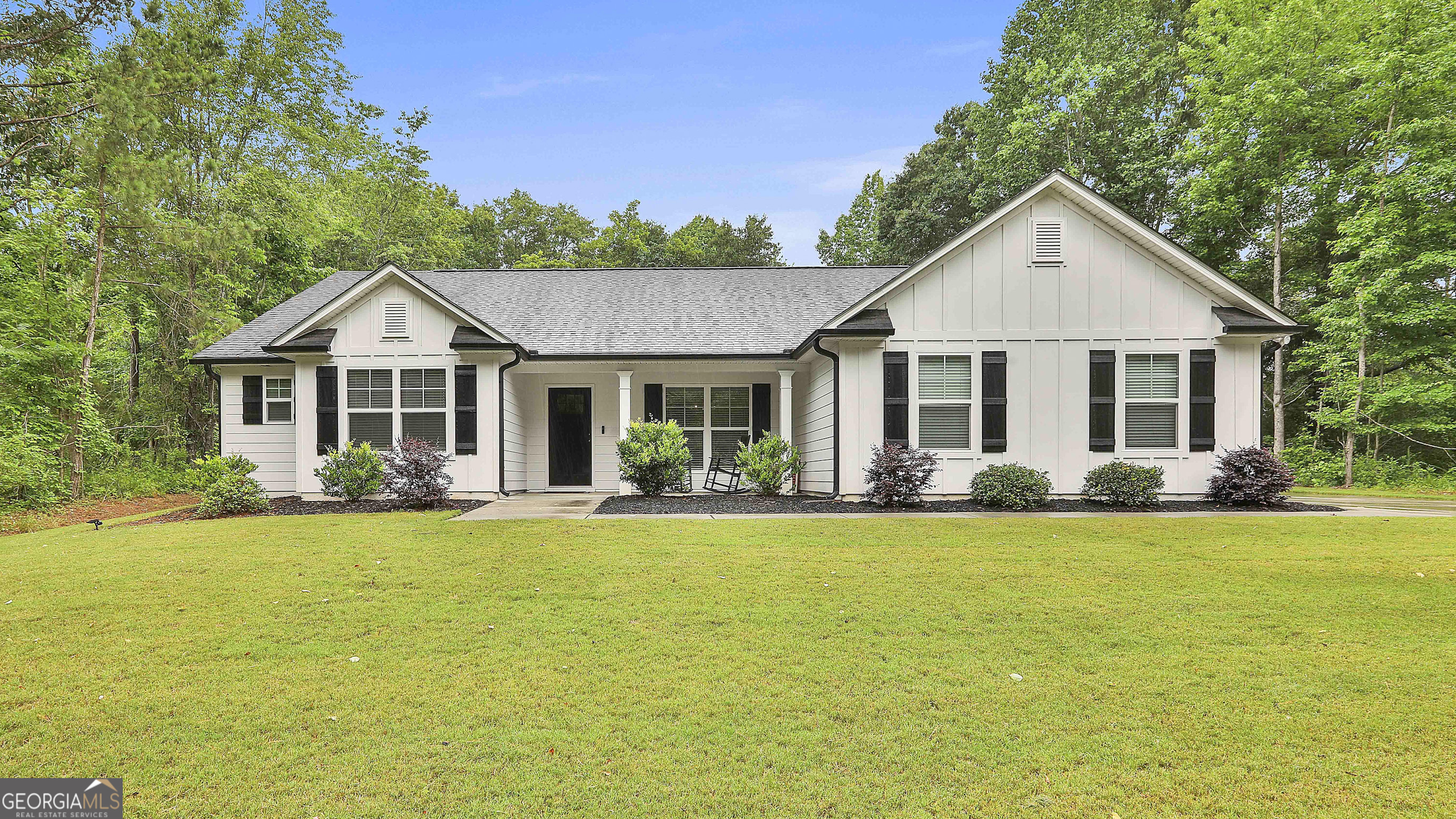 a front view of house with yard and green space