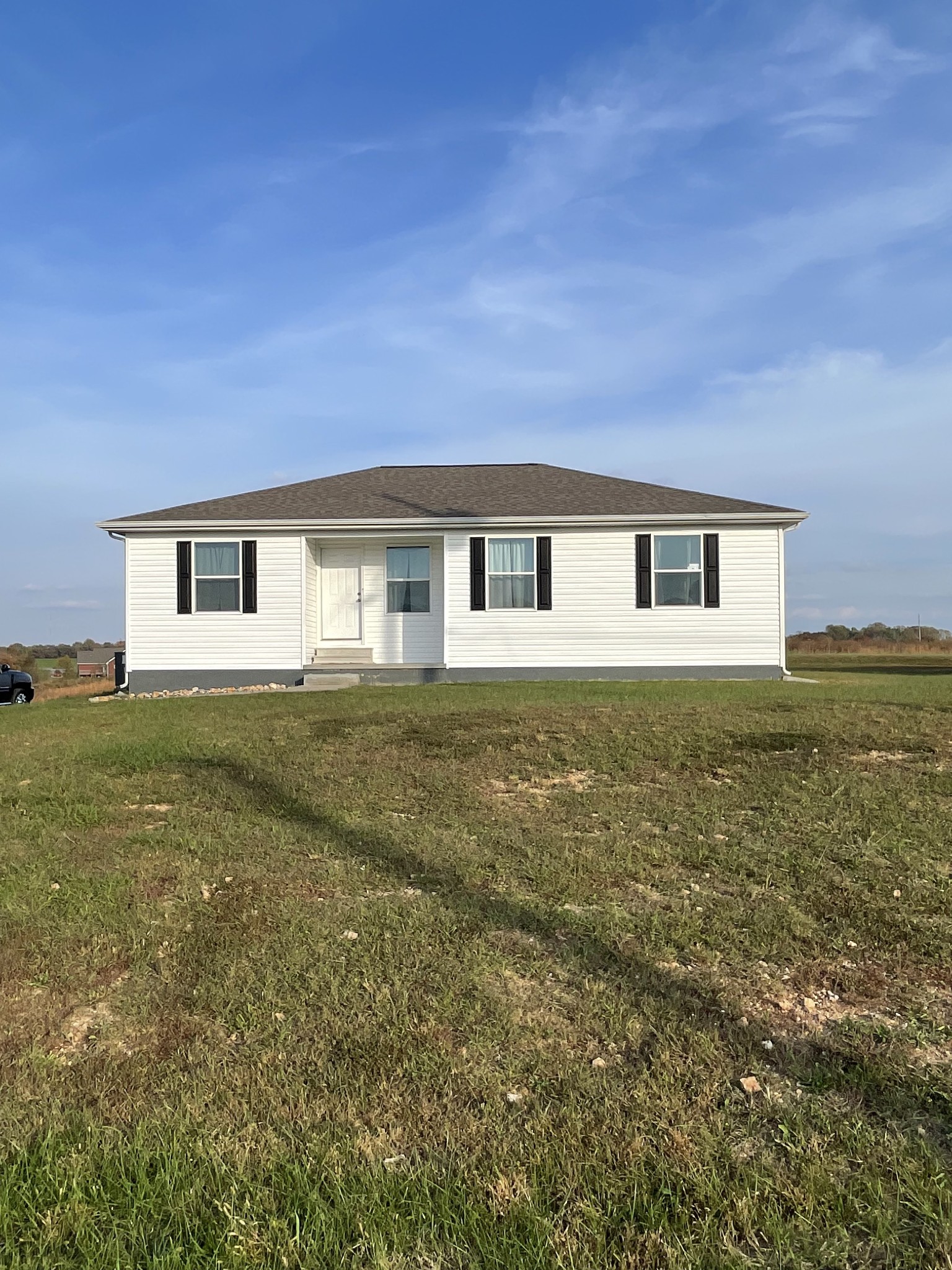 a view of house with backyard