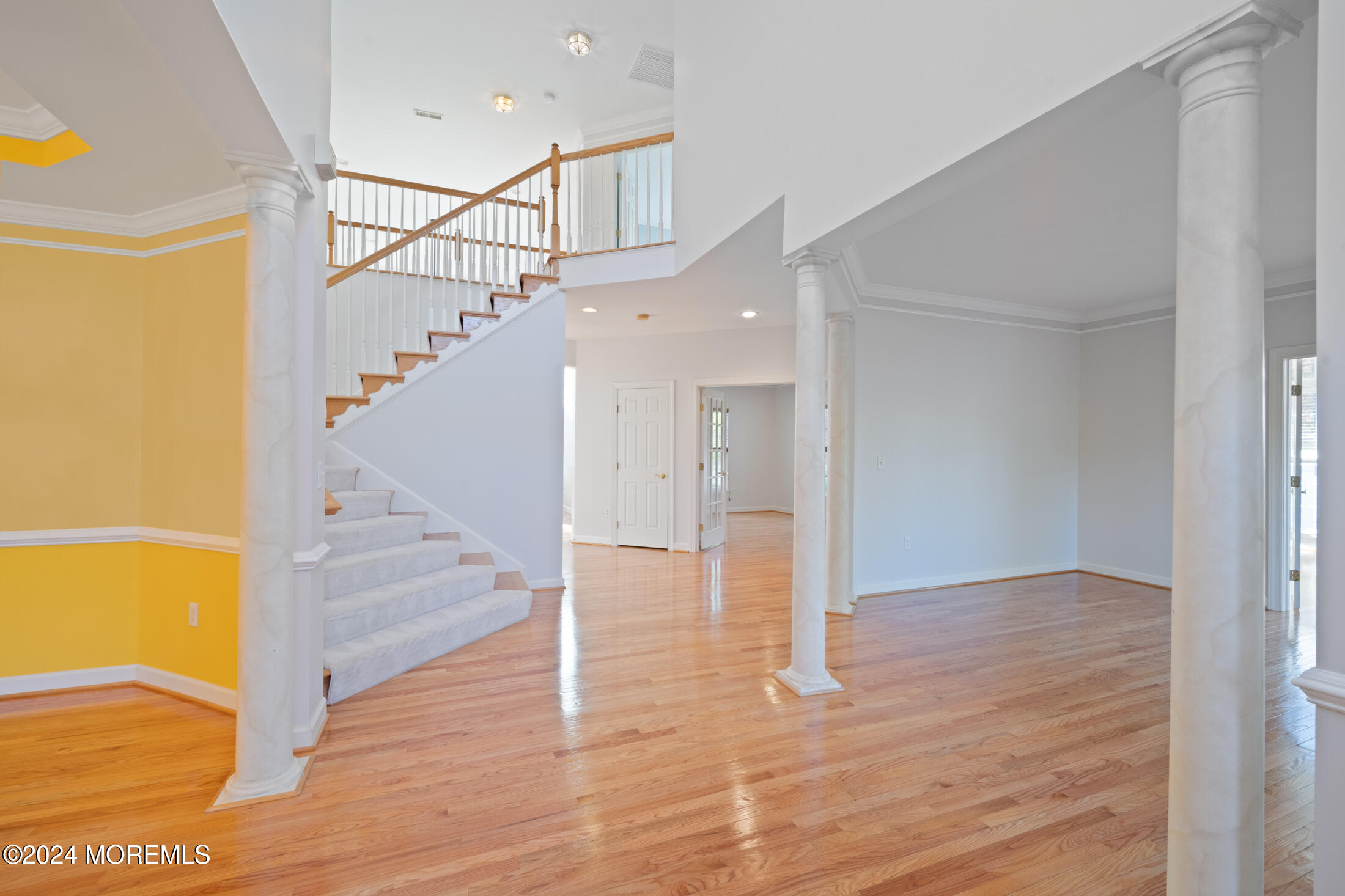 a view of entryway and hall with wooden floor