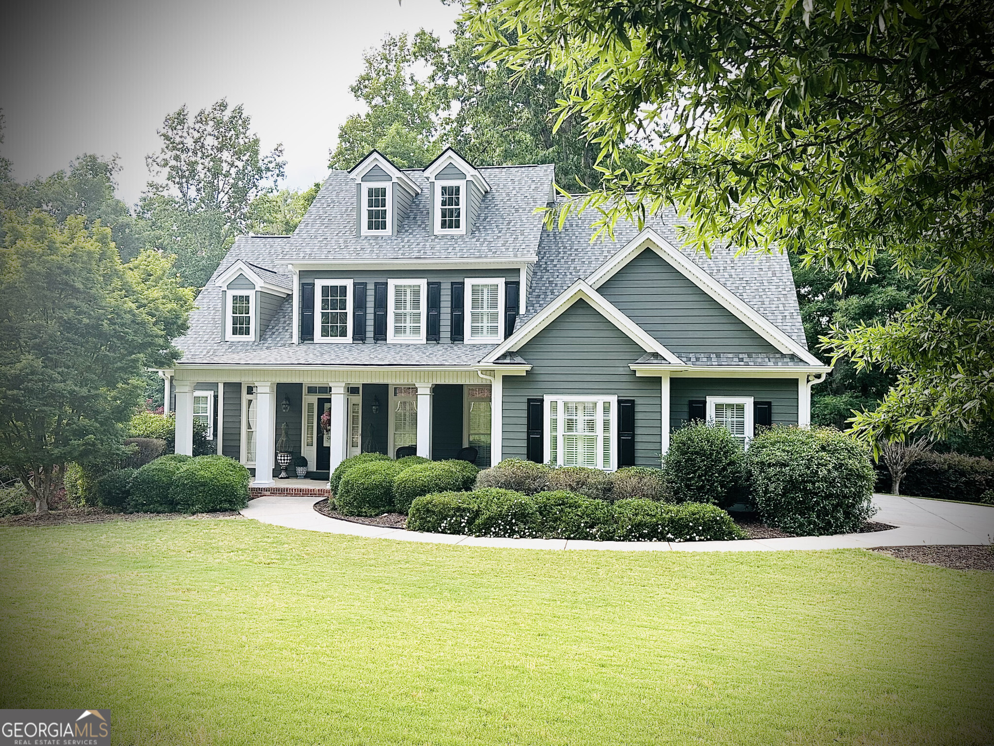 a front view of a house with a garden