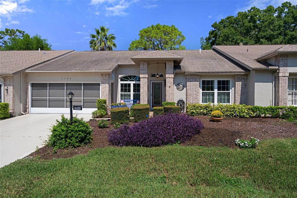 a front view of a house with a garden