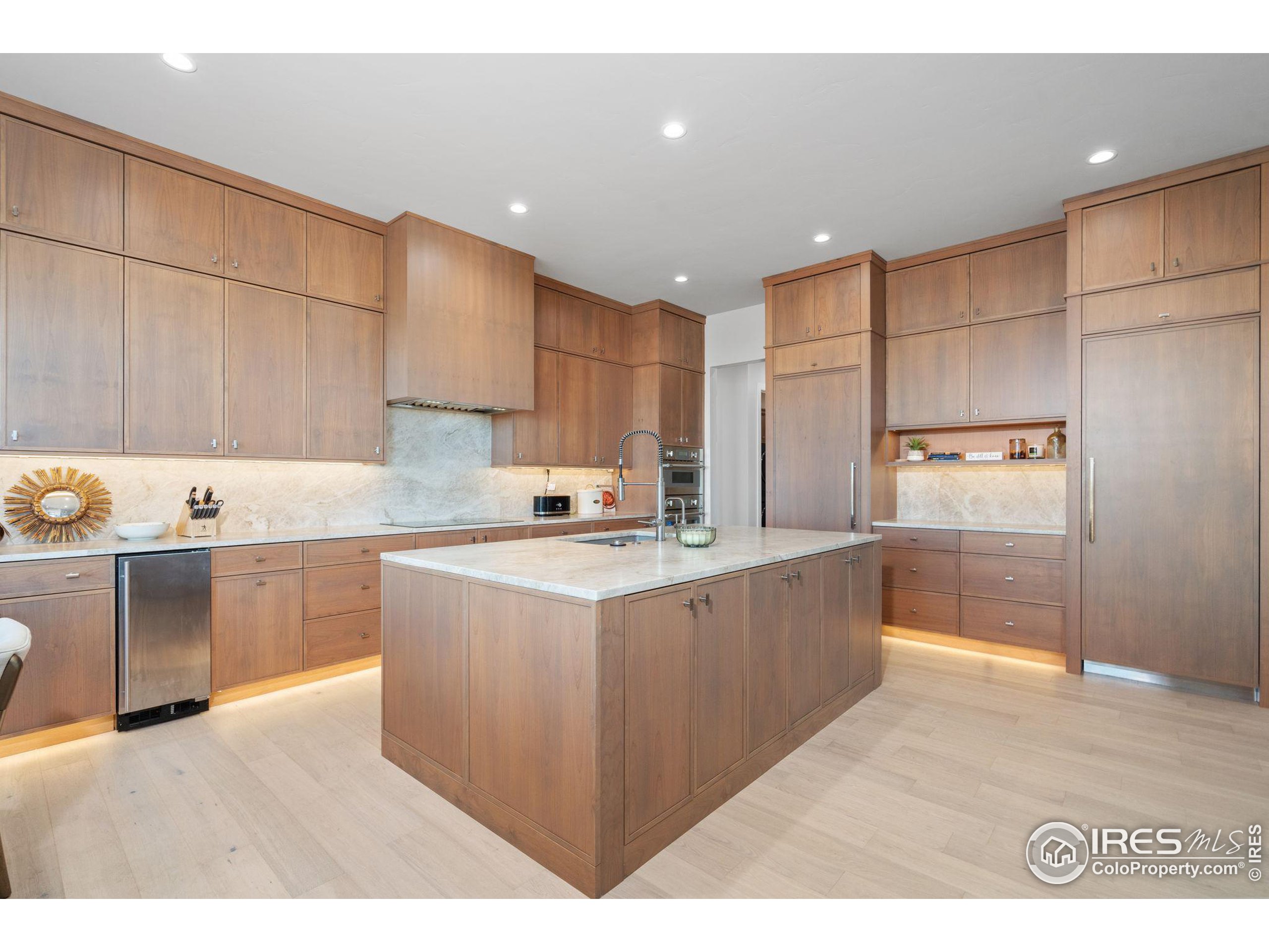 a kitchen with kitchen island cabinets a sink a counter and appliances