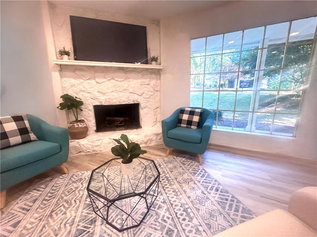 a living room with furniture a flat screen tv and a fireplace