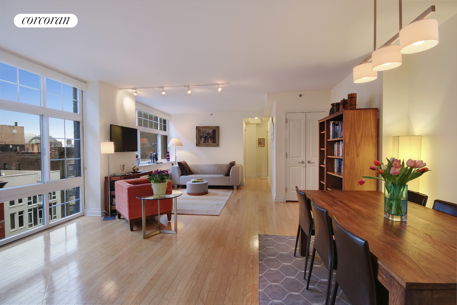 a living room with furniture and a wooden floor