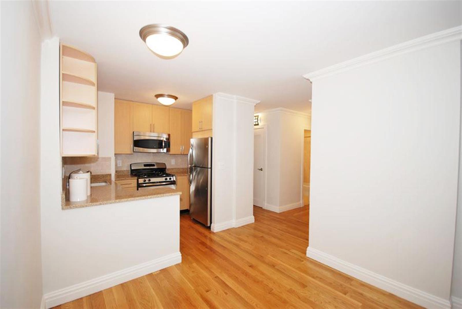 a kitchen with stainless steel appliances a refrigerator and a stove top oven