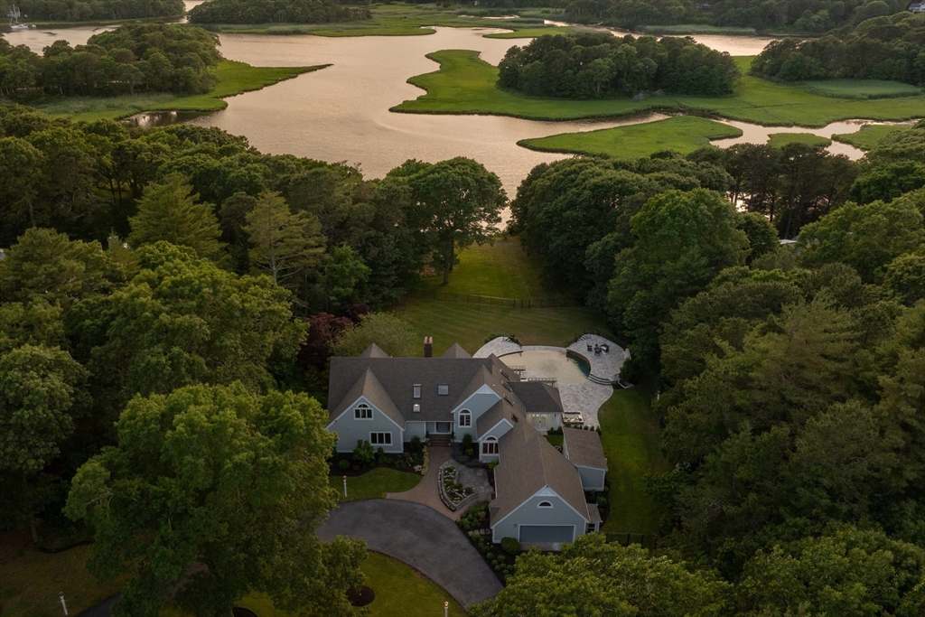 an aerial view of a house with yard lake and green space