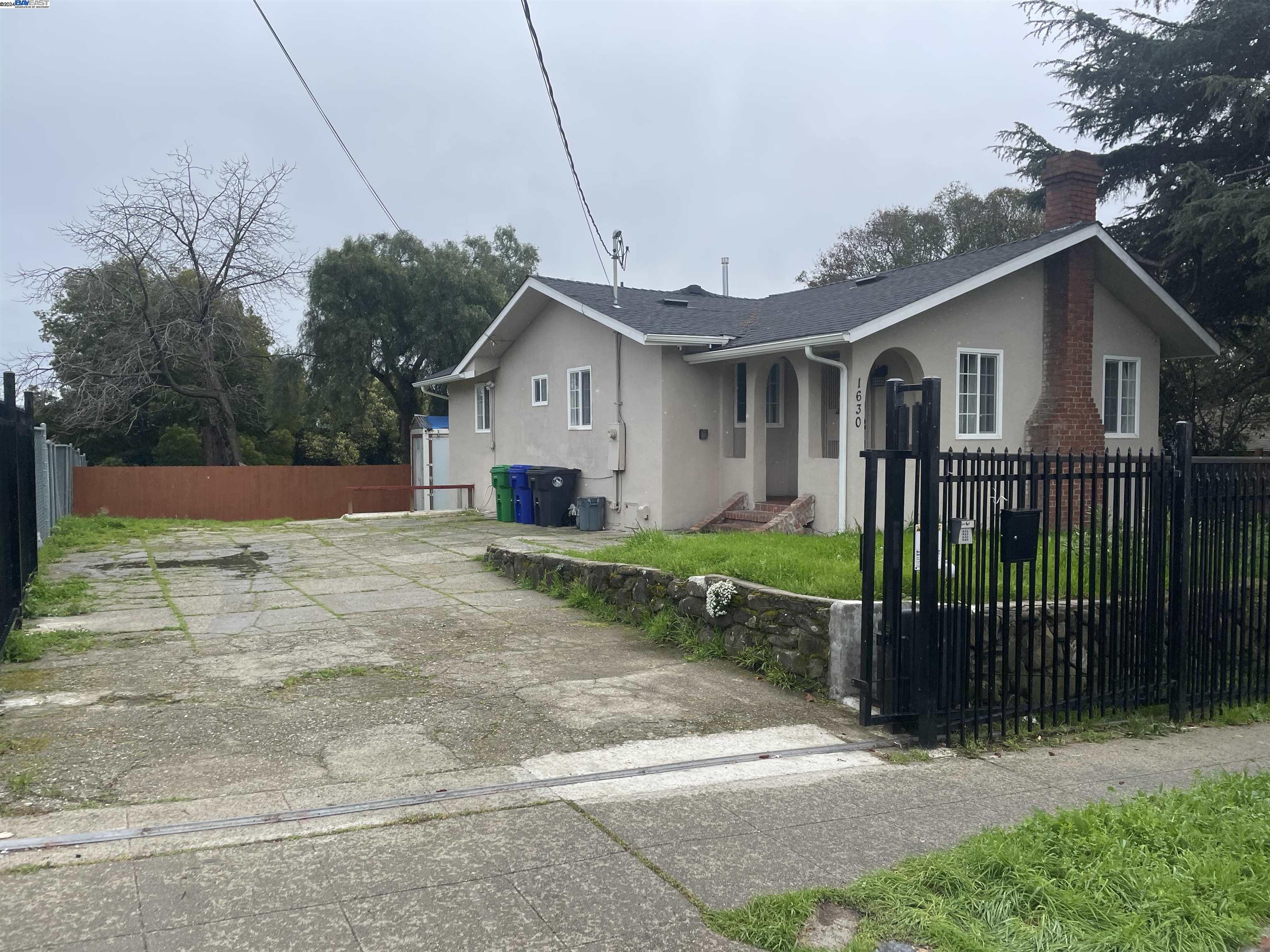 a view of a house with a yard and fence