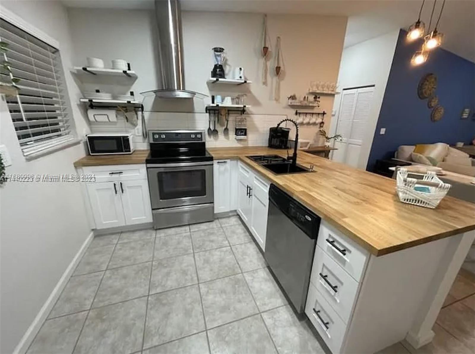 a kitchen with a stove cabinets and a sink