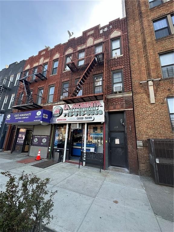 a front view of a building and car parked