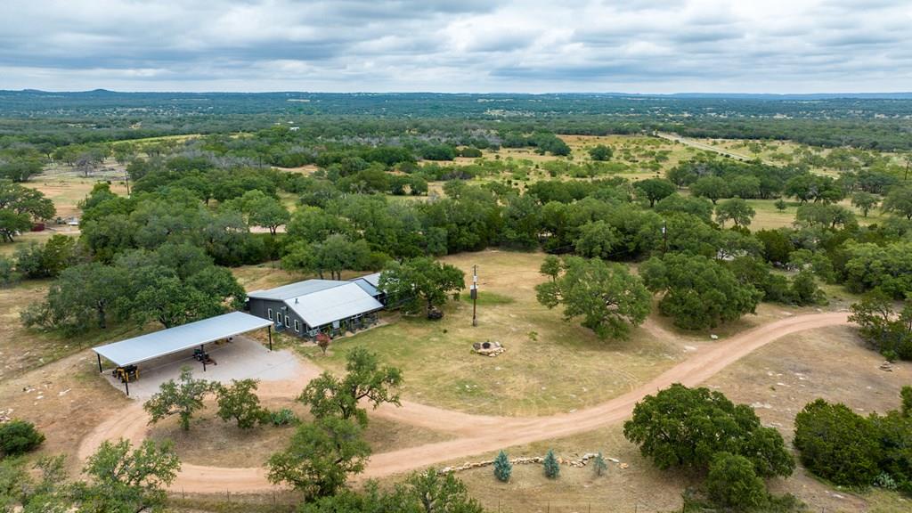 an aerial view of a house with a yard