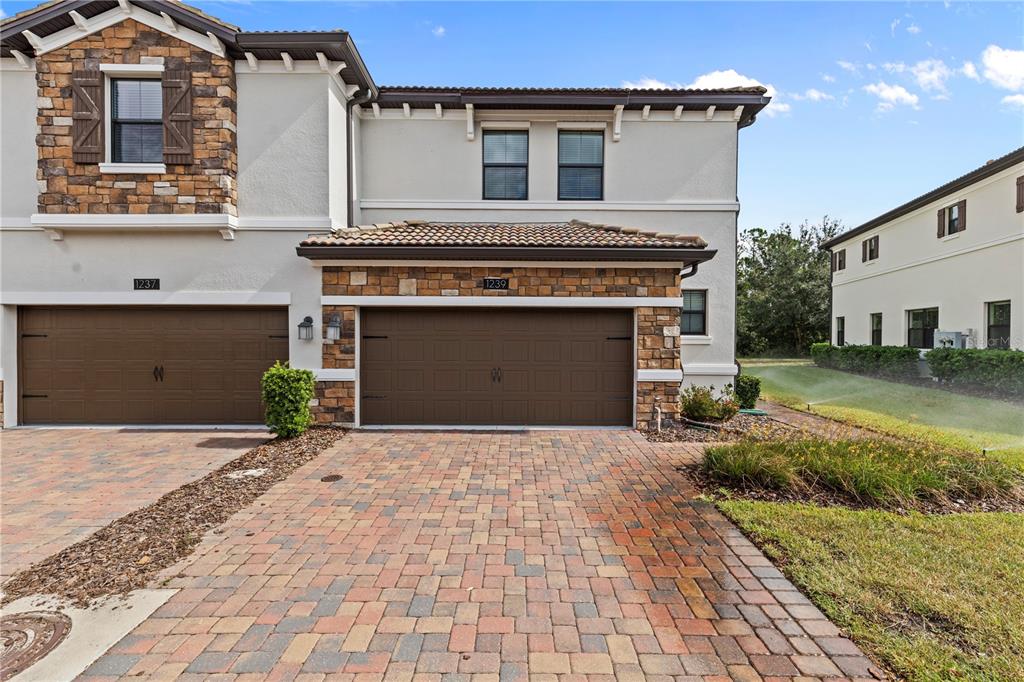 a front view of a house with a yard and garage