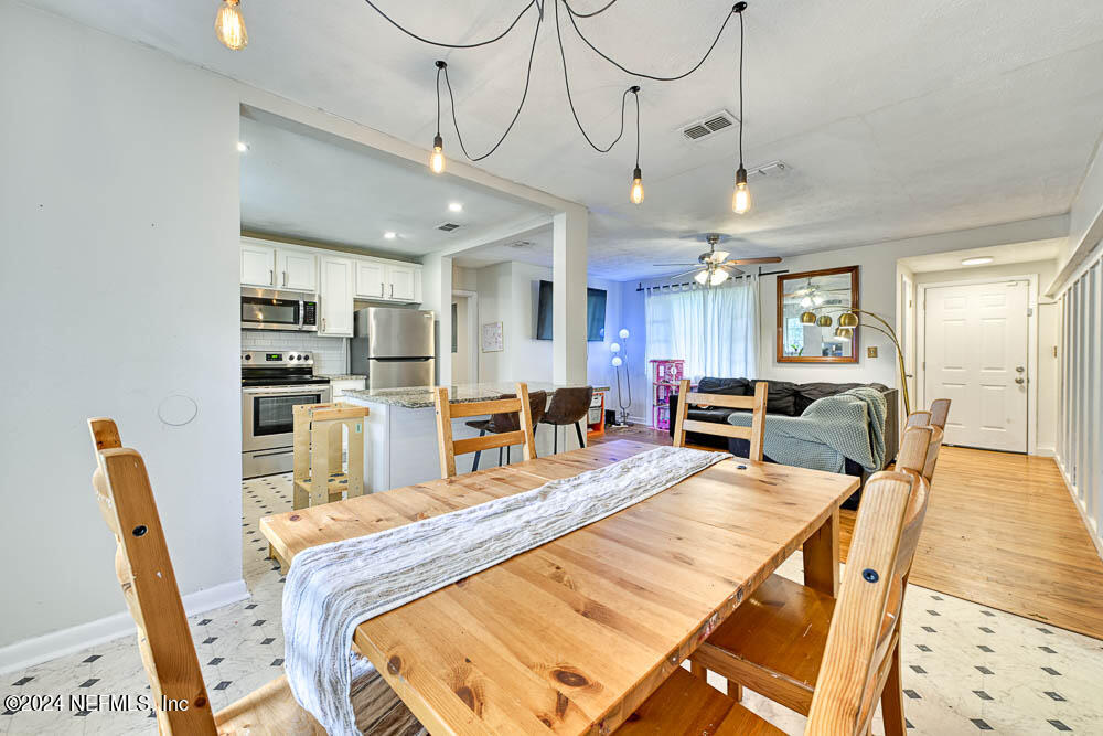 a large kitchen with a table and chairs