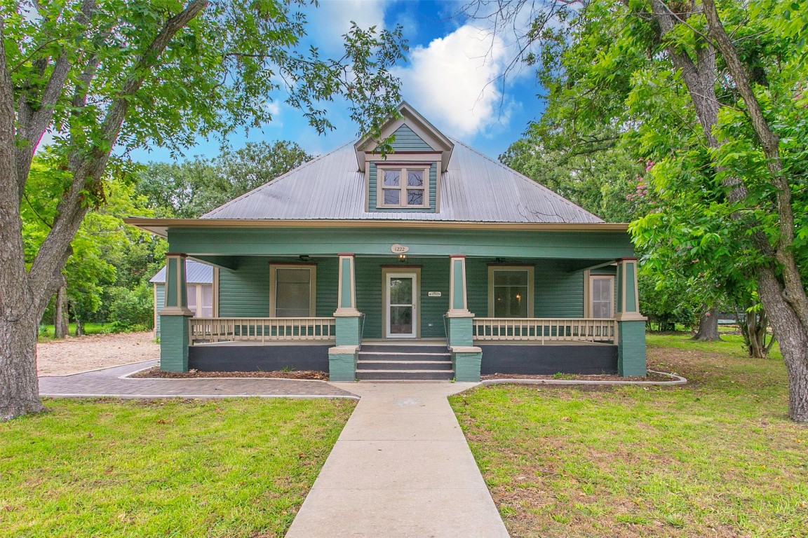 a front view of a house with a garden and porch