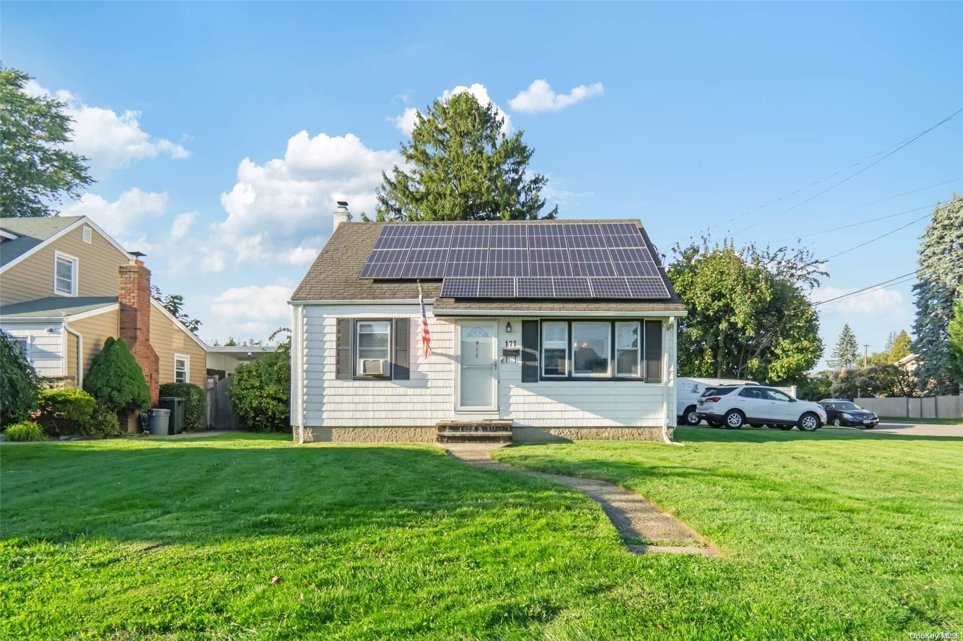 a front view of a house with a yard table and chairs