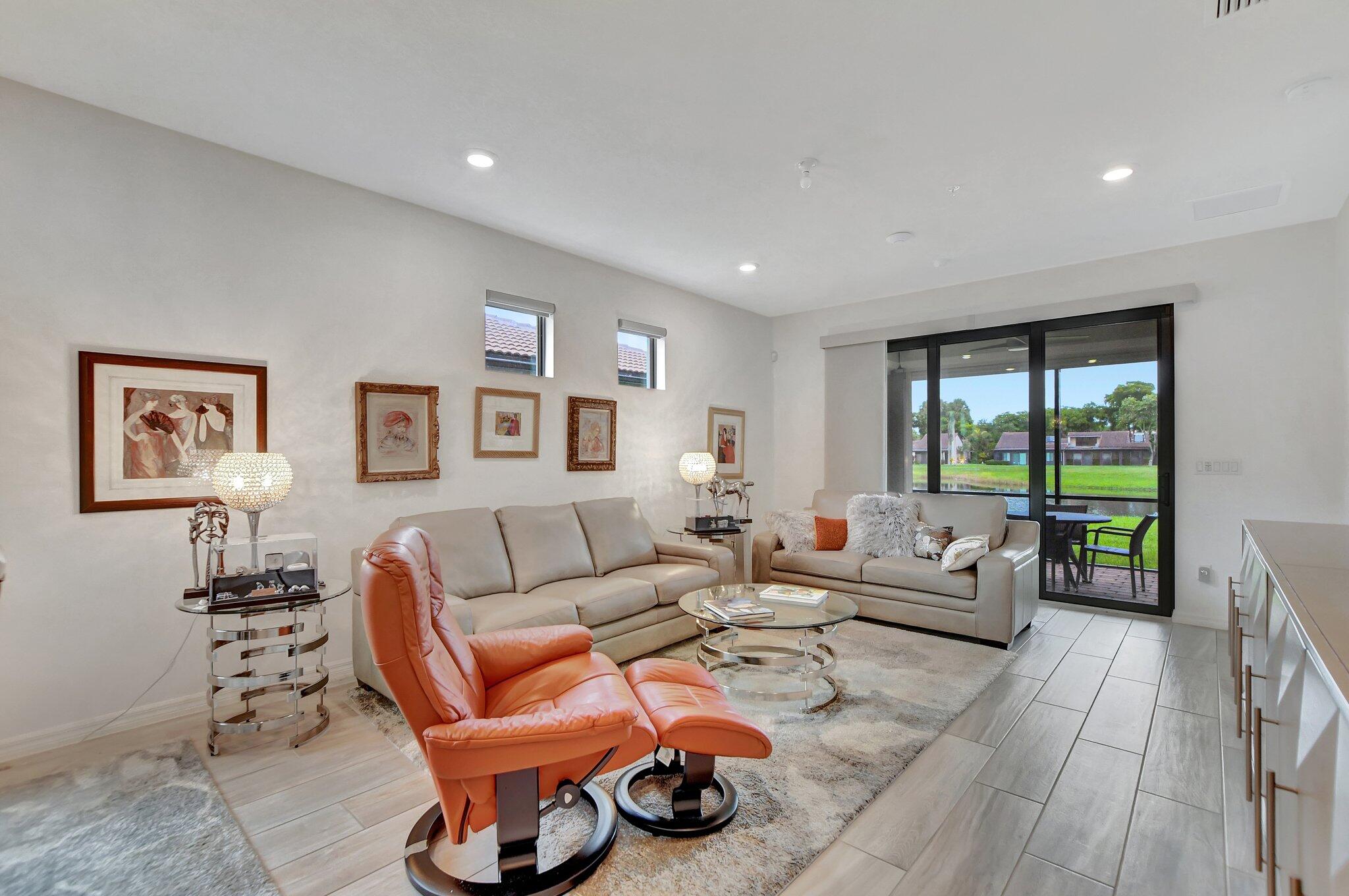 a living room with furniture a rug and a large window