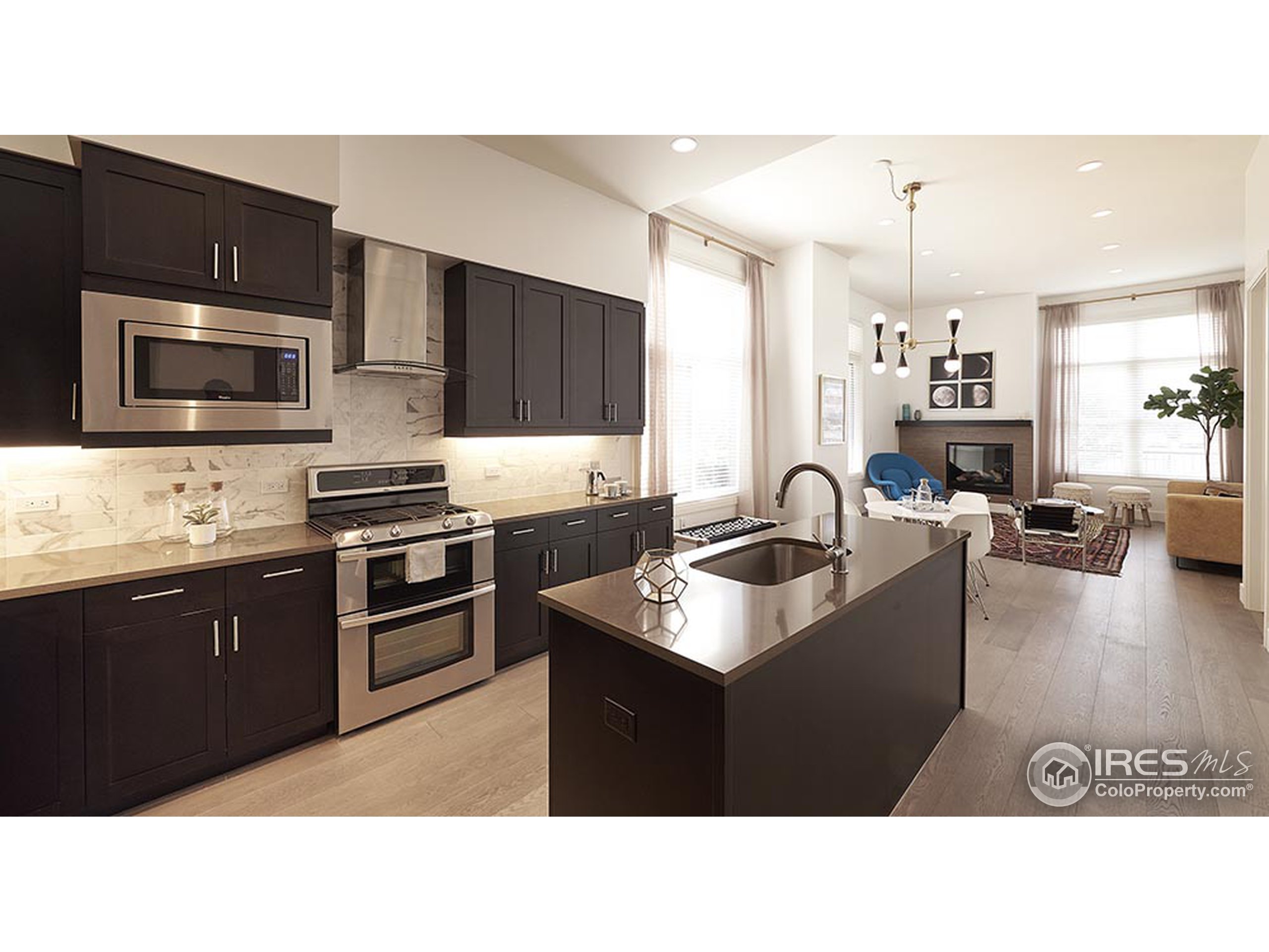 a kitchen with kitchen island a sink stainless steel appliances and cabinets