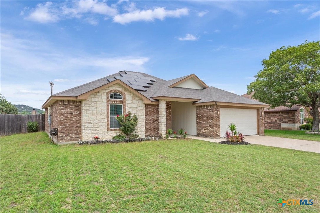 a front view of a house with a yard and garage