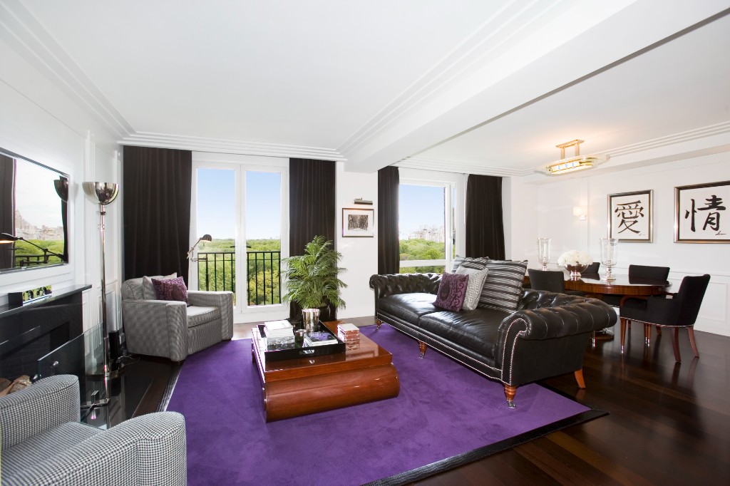 a living room with furniture rug and a large window