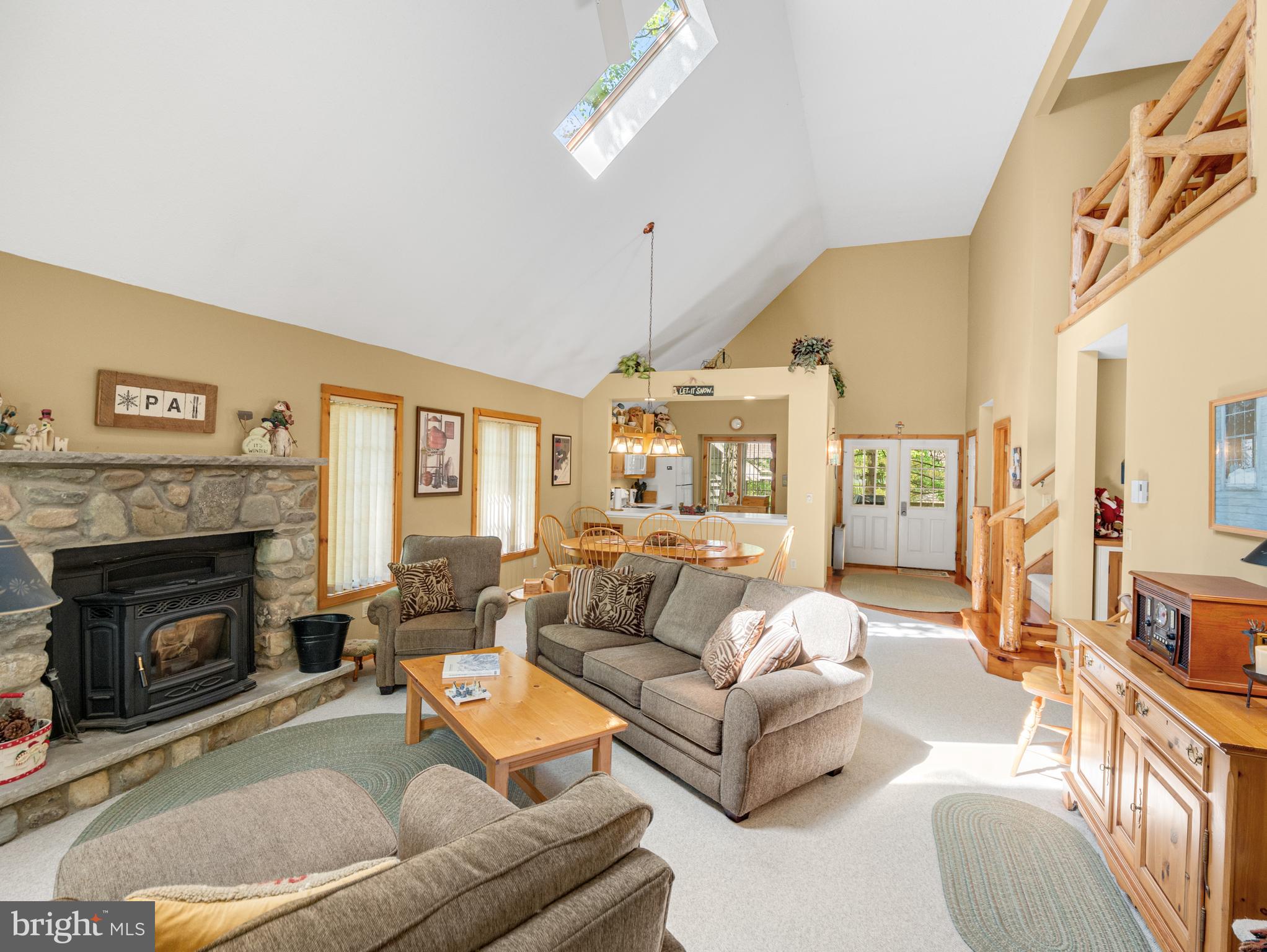 a living room with furniture a fireplace and a large window