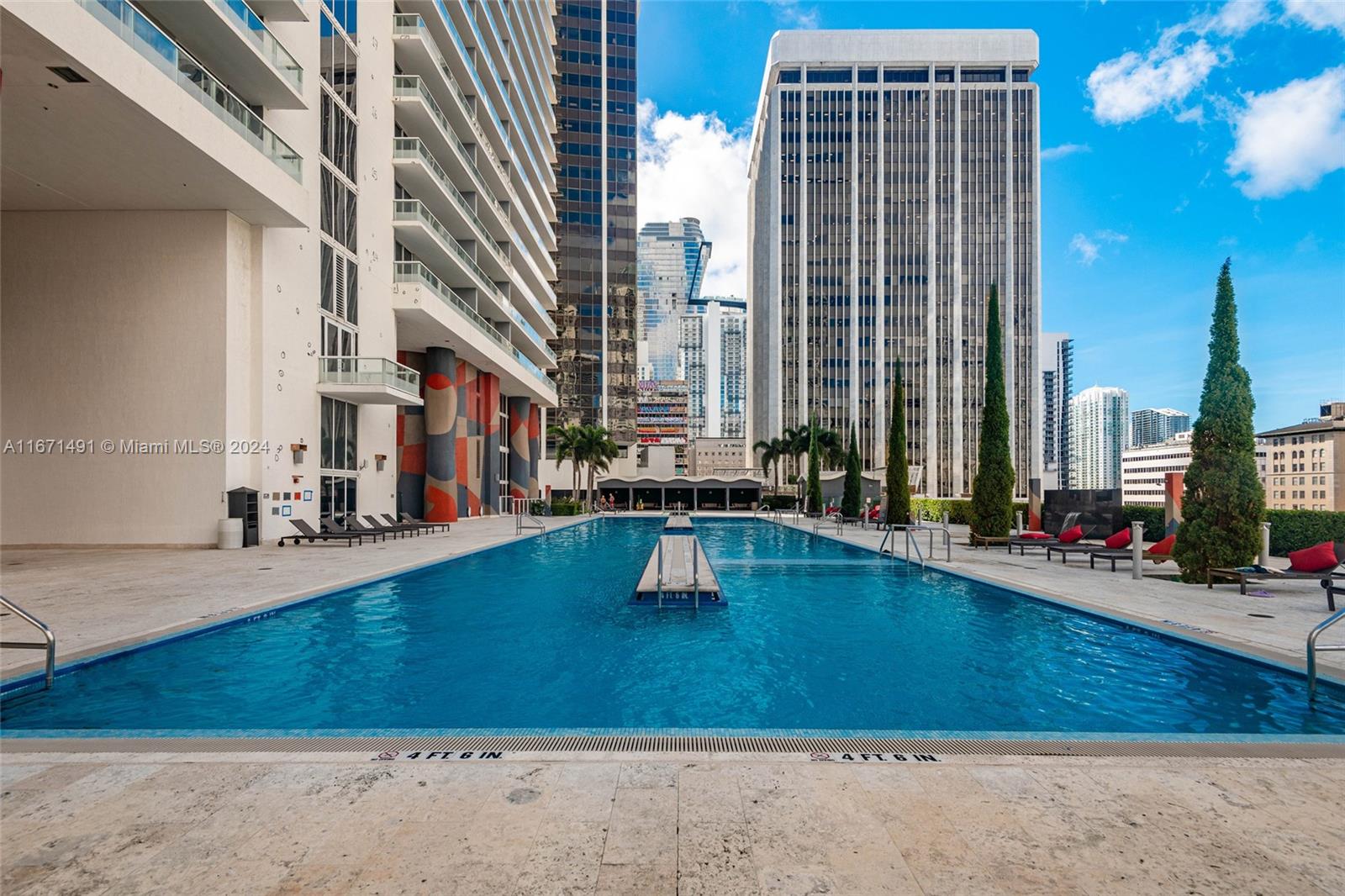 a swimming pool with outdoor seating and yard