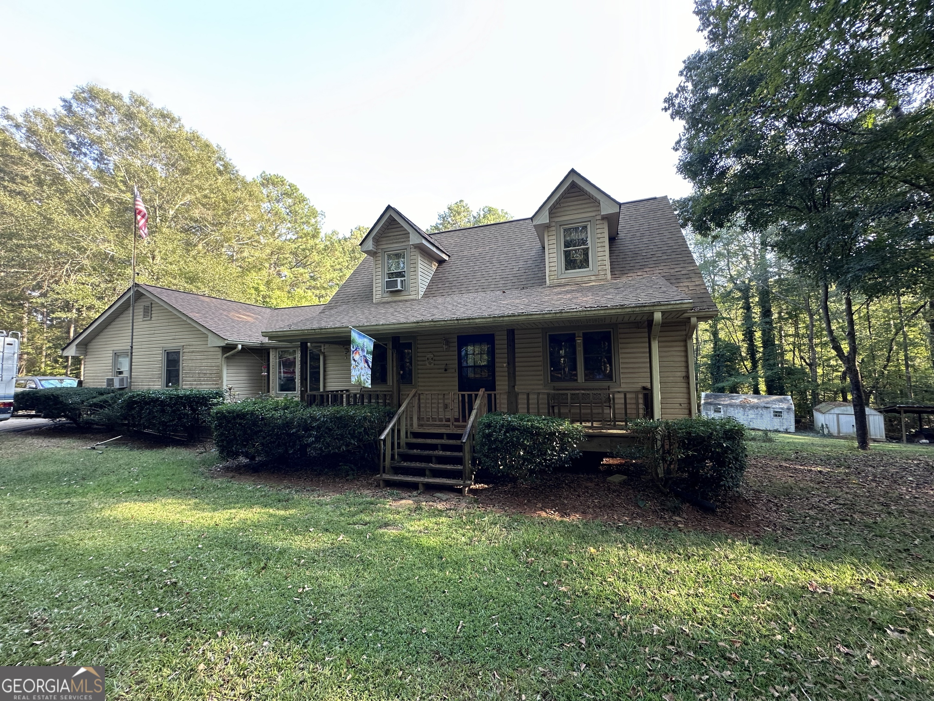 a front view of a house with a garden