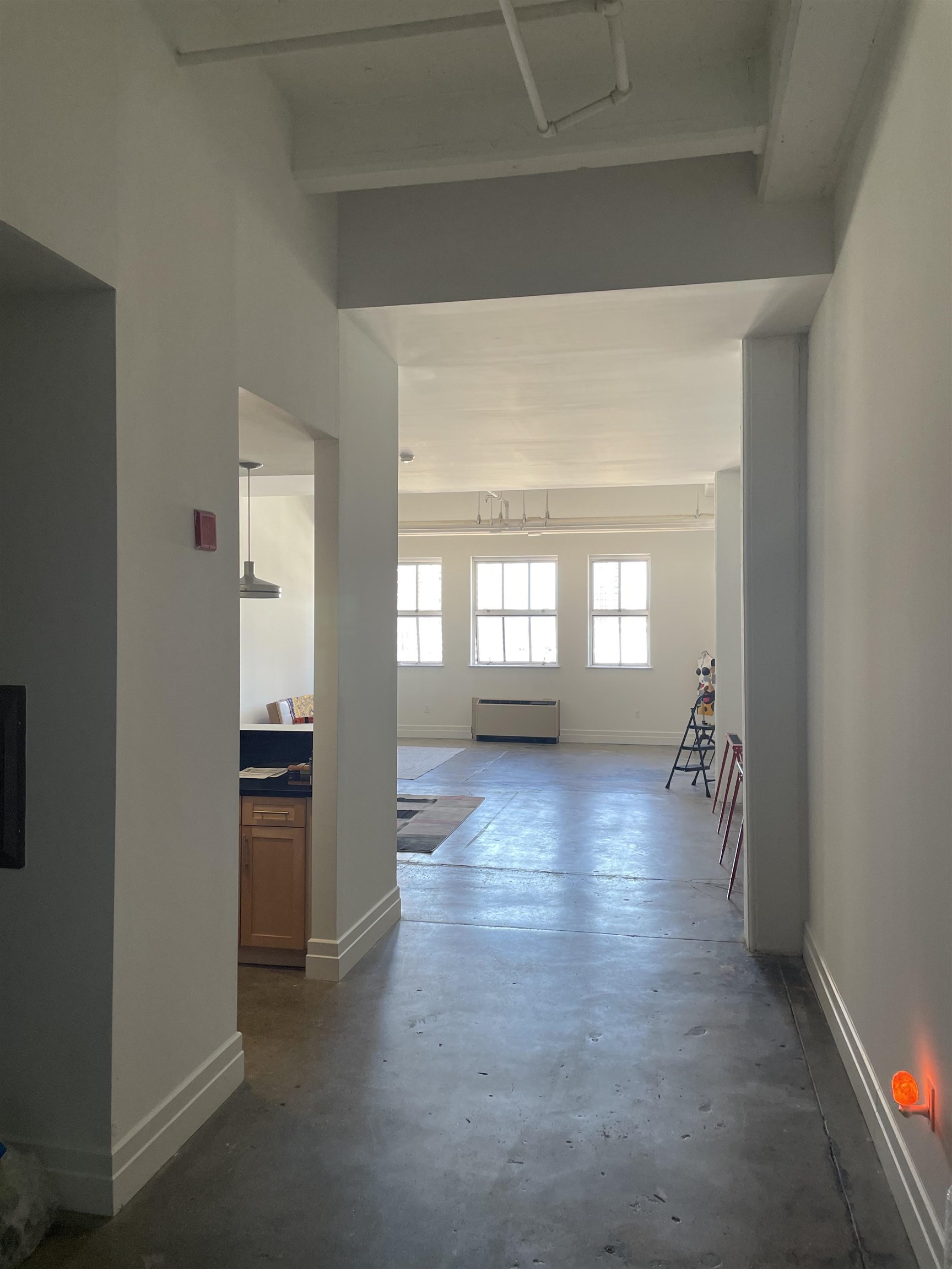 wooden floor in kitchen and a livingroom with a window