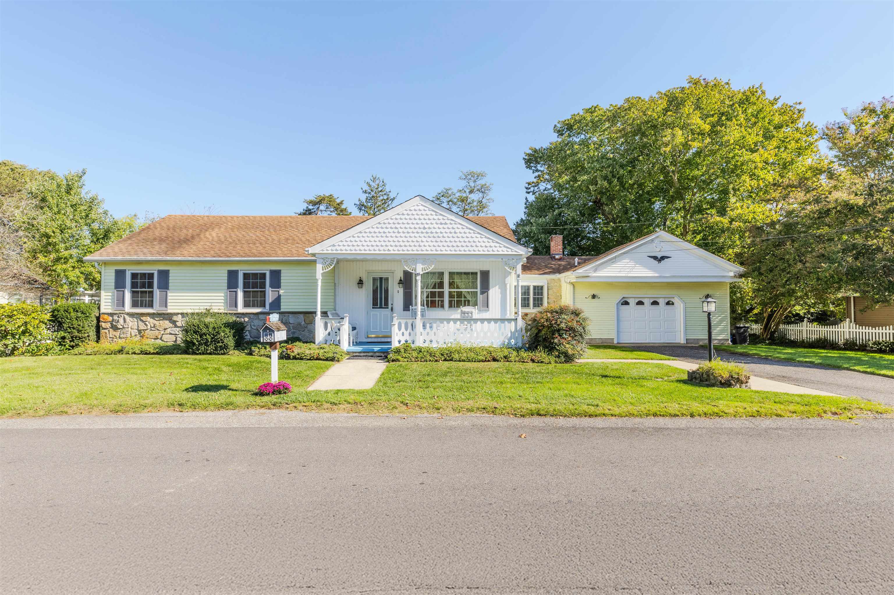 a front view of a house with a yard and porch