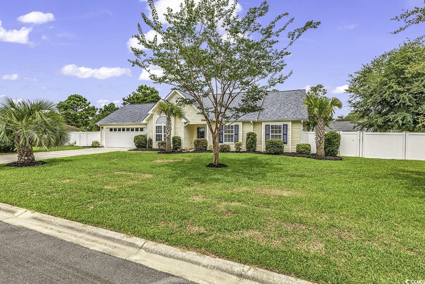 View of front of home featuring a garage and a fro