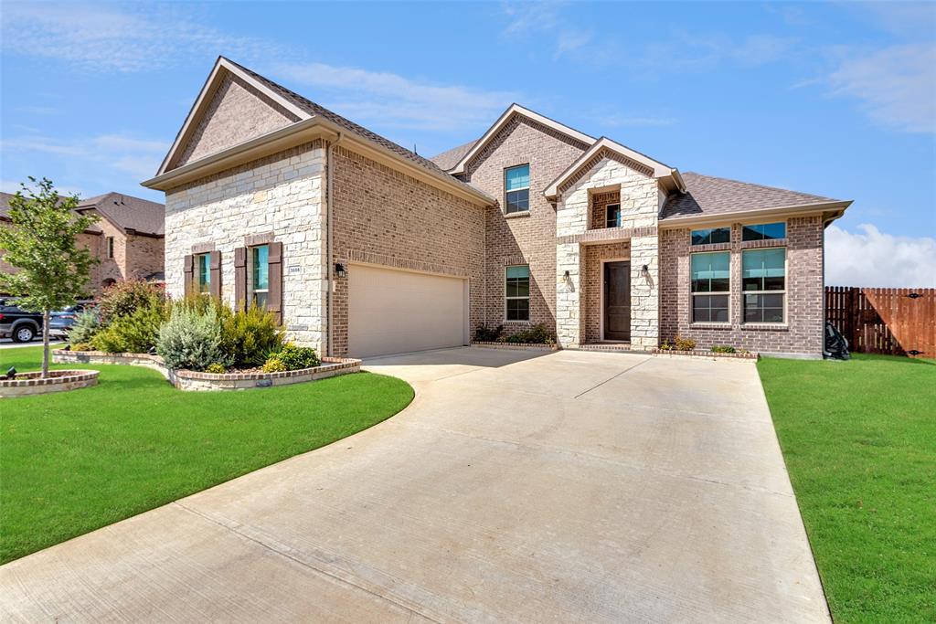 a front view of a house with a yard and porch