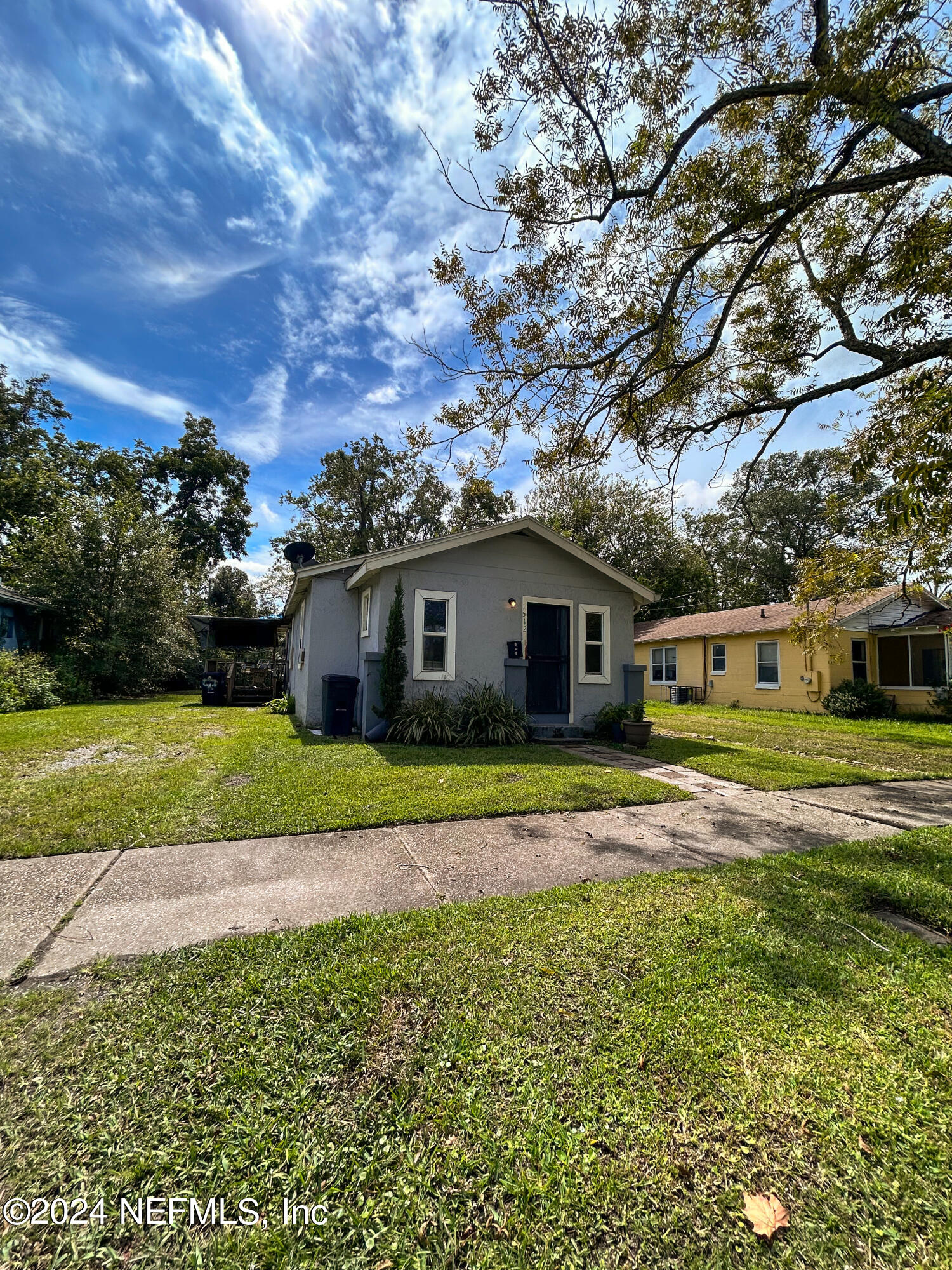 a front view of house with yard and green space