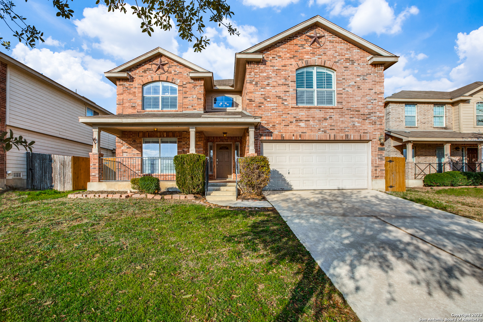 a front view of a house with a yard and garage