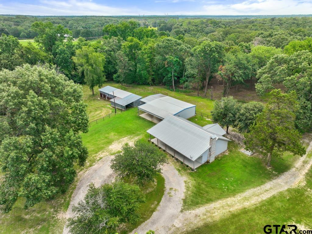 an aerial view of a house with a yard