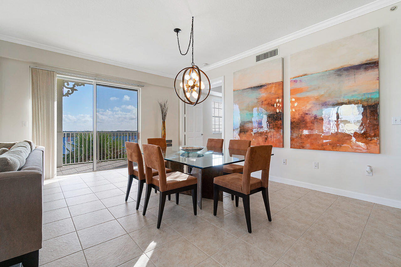 a view of a dining room with furniture a chandelier and wooden floor