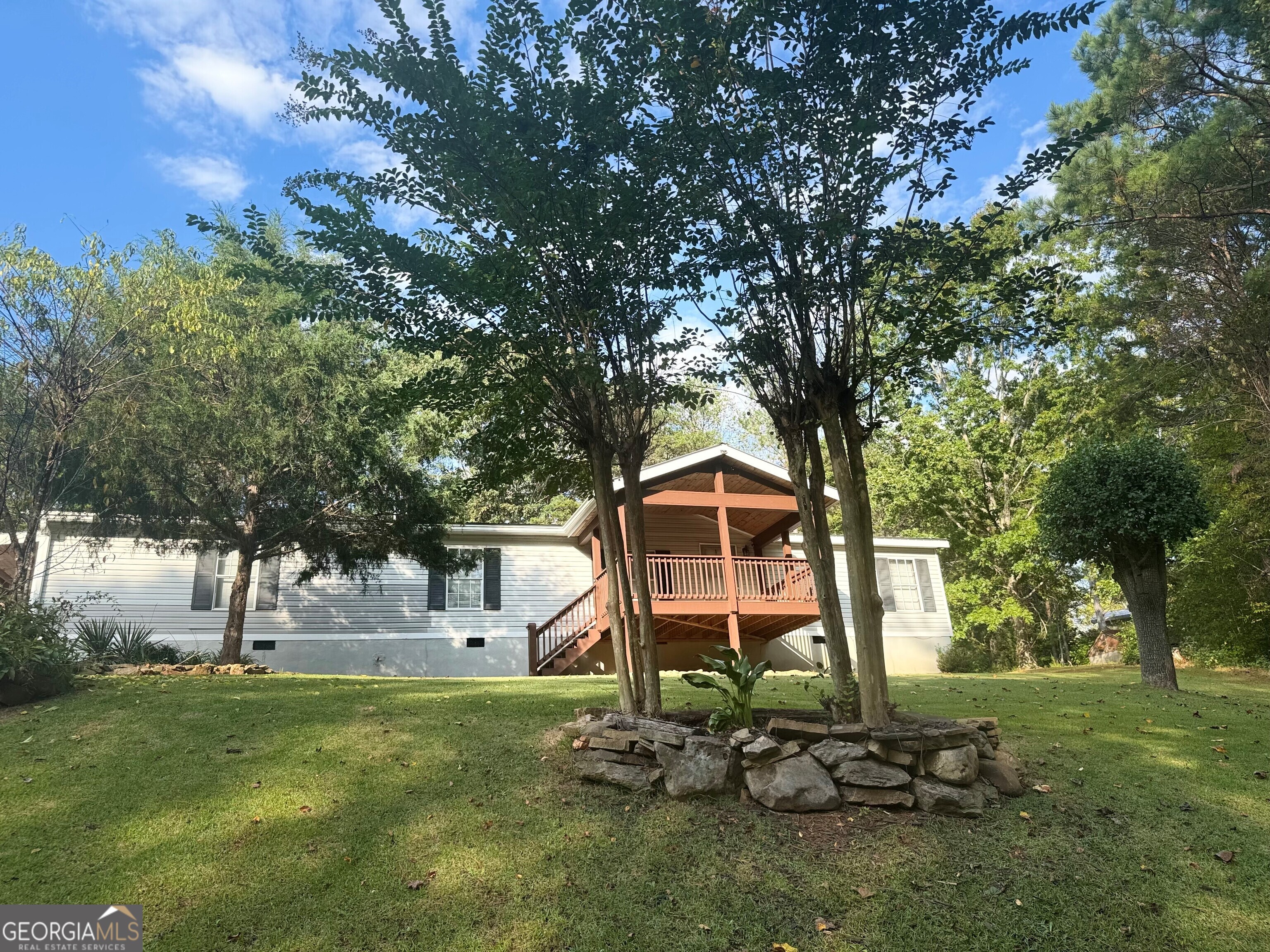 a backyard of a house with table and chairs