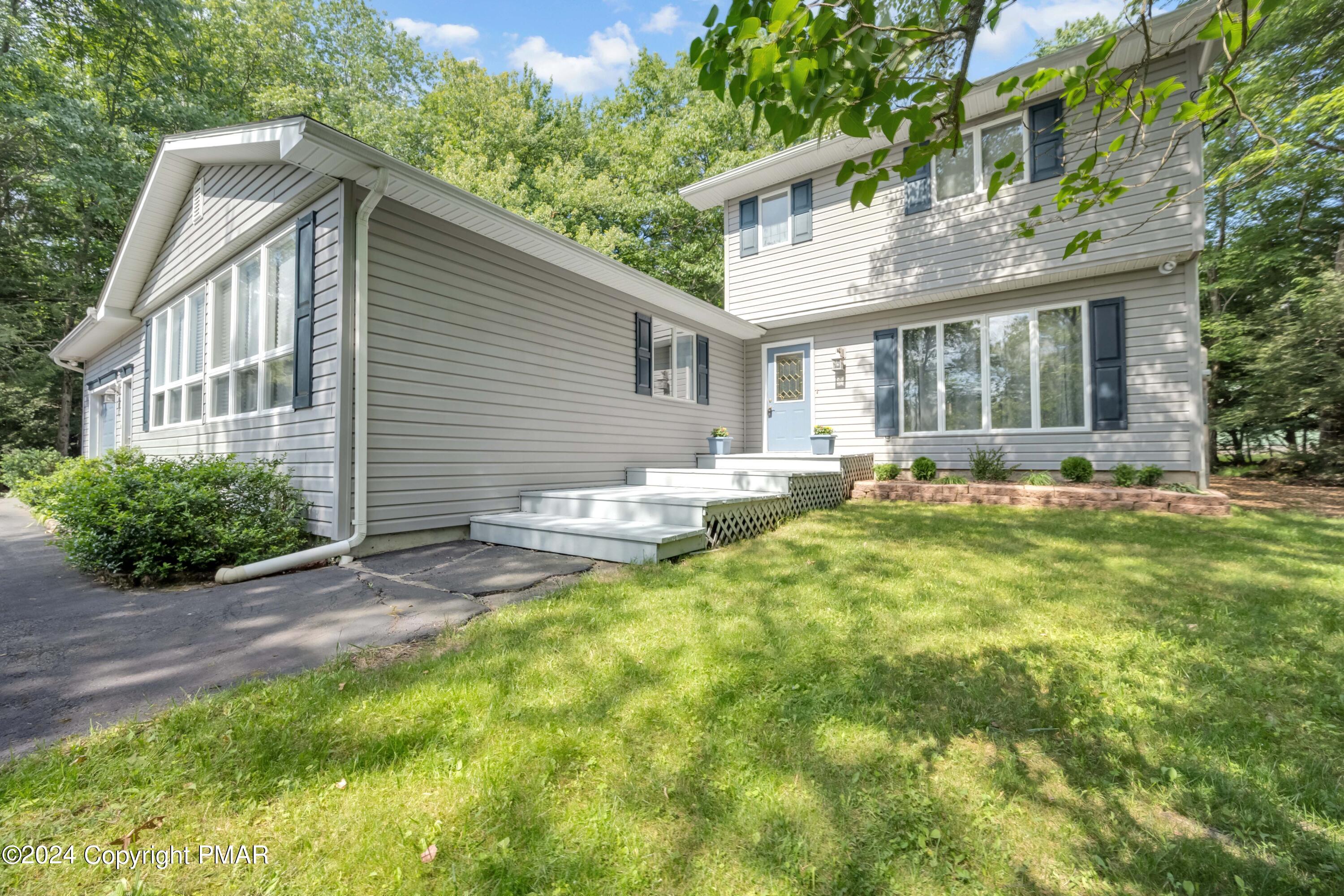 a front view of house with yard and green space