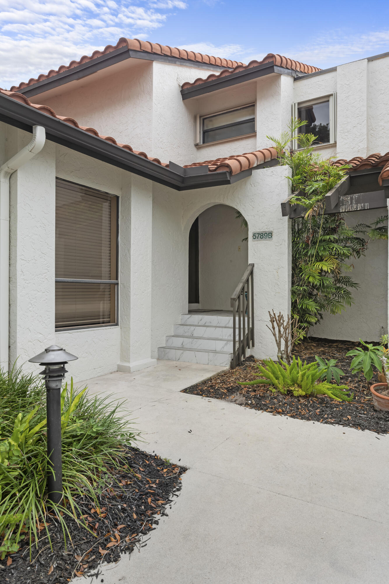 a front view of a house with garden