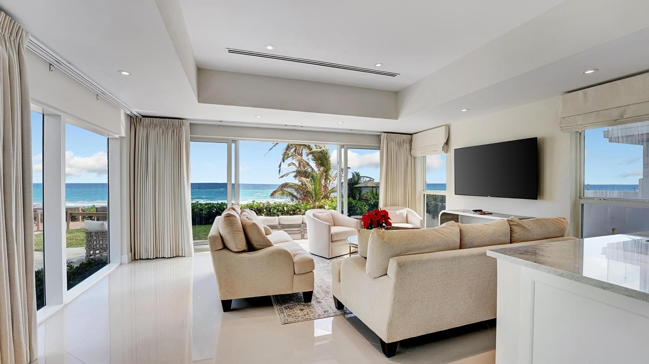 a living room with furniture and large flat screen tv