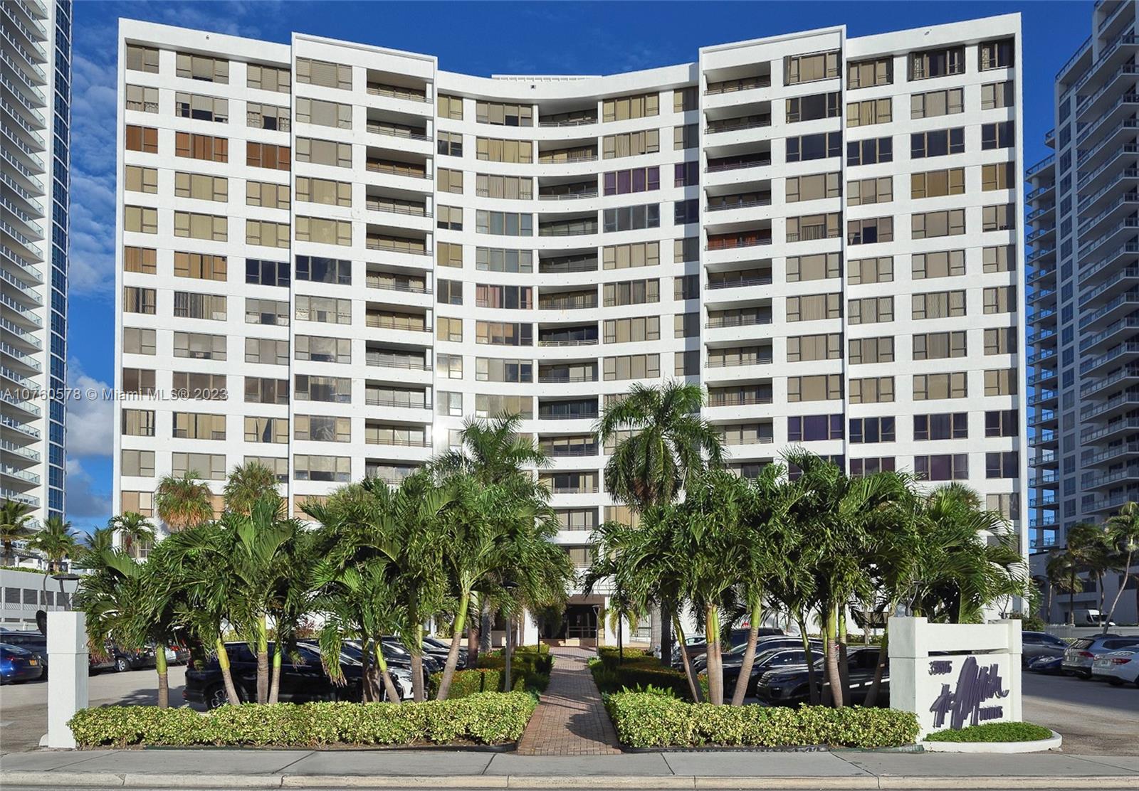 a front view of a building with plants