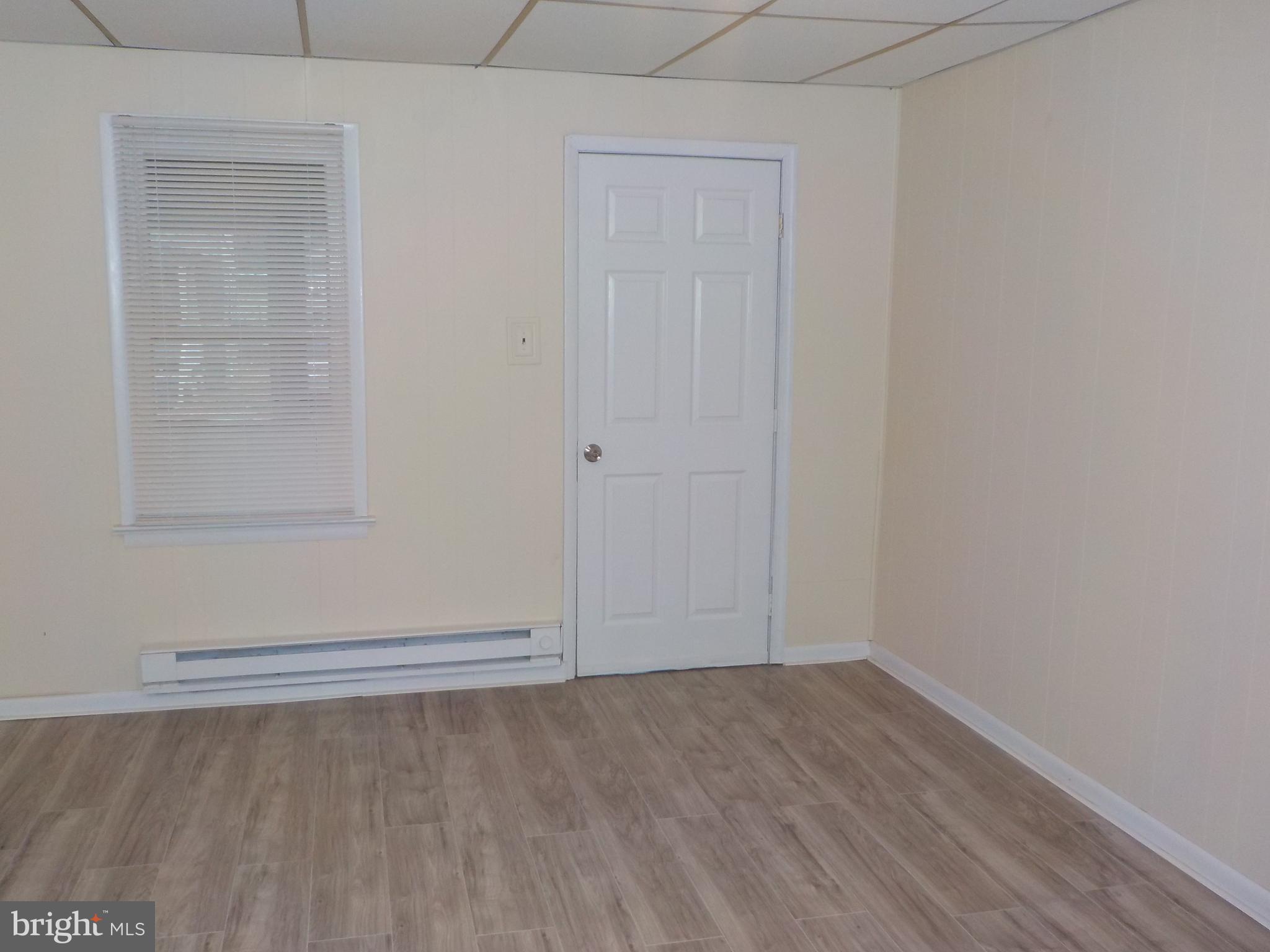 an empty room with a empty space and windows