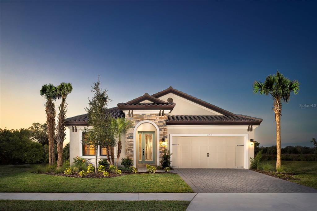 a front view of a house with a yard and garage