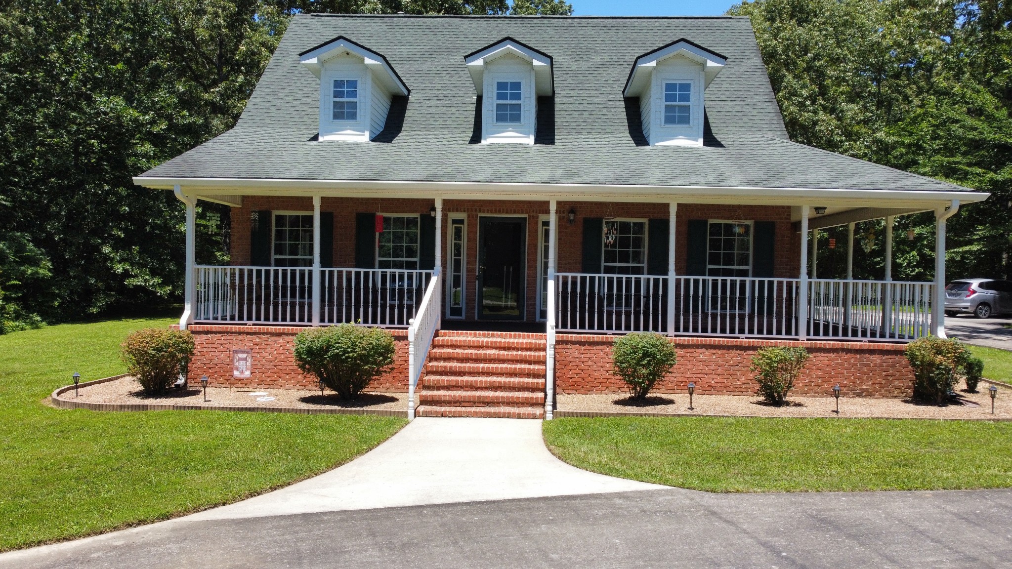 a front view of a house with garden