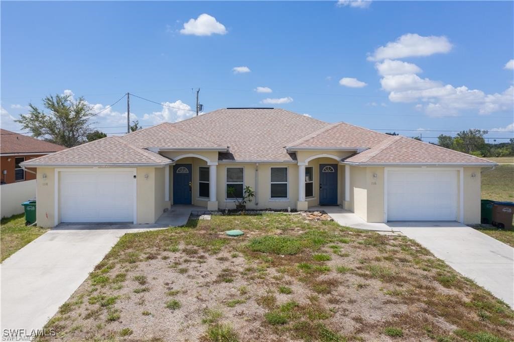 a front view of a house with a yard and garage