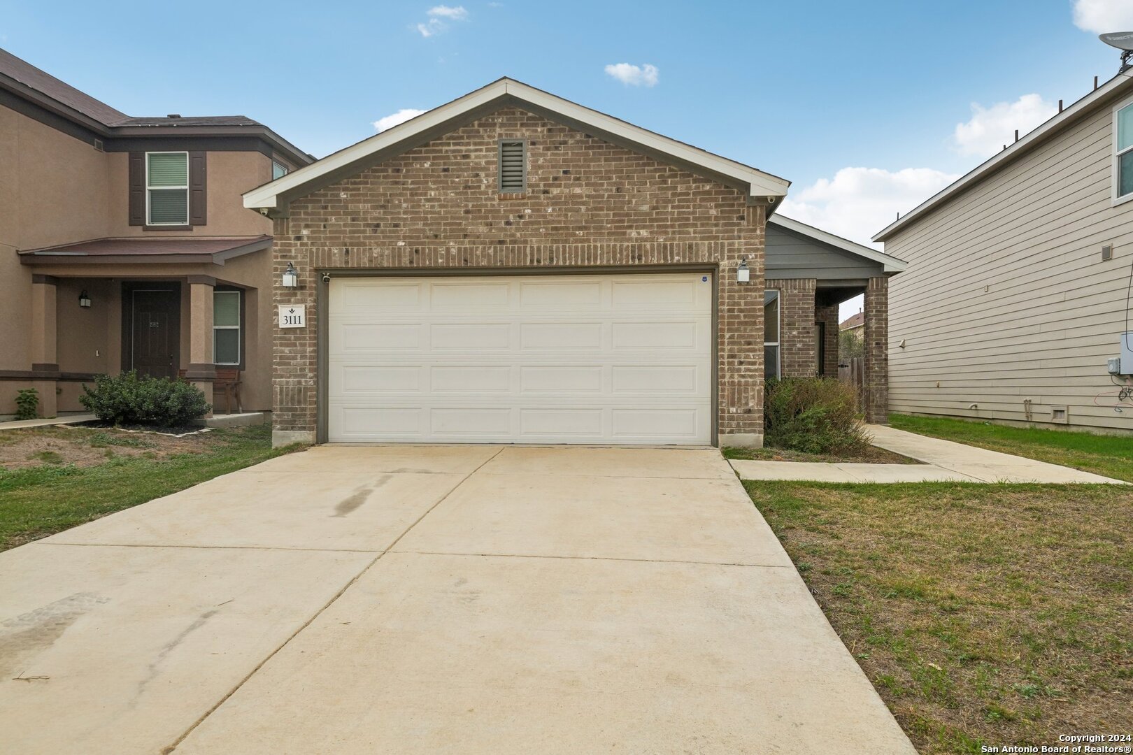 a front view of the house with garage