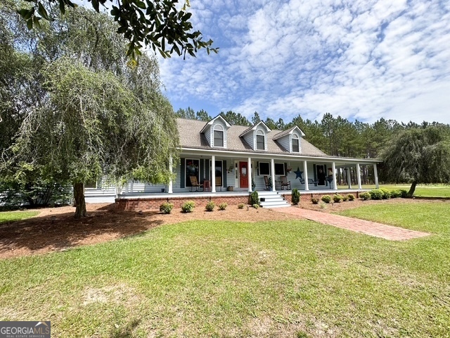 front view of a house with swimming pool and chairs