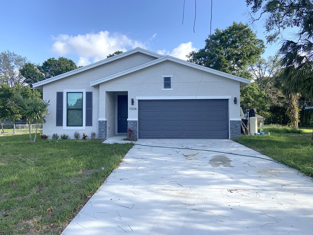 a front view of house with yard and green space