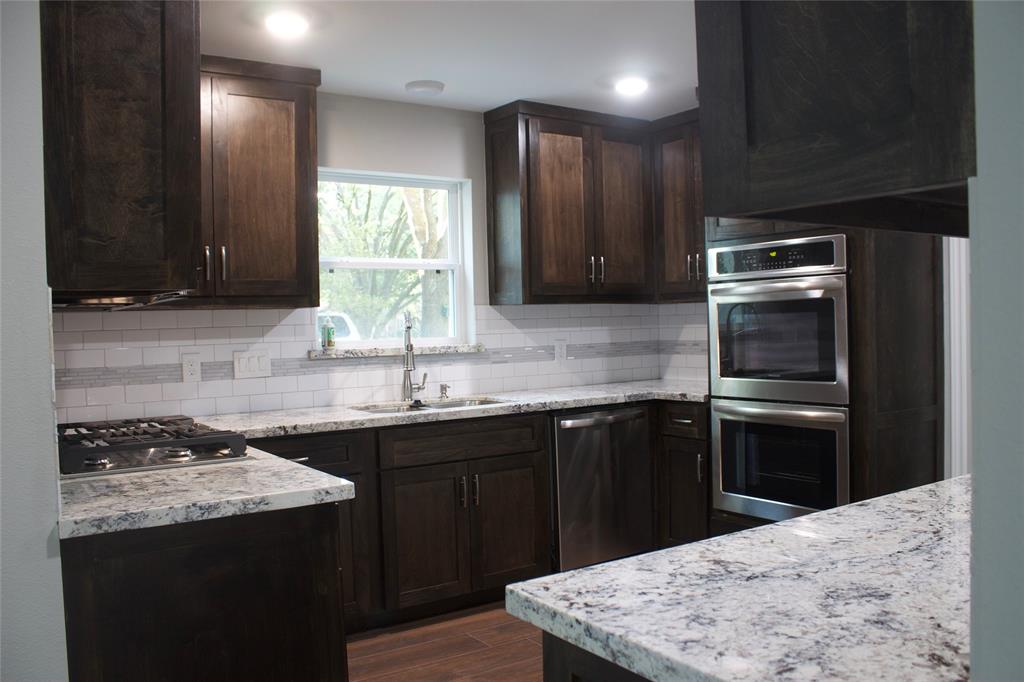 a kitchen with a sink stove and refrigerator