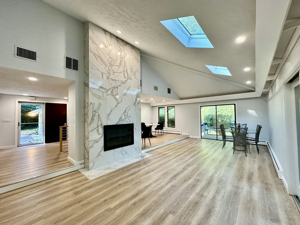 an empty room with fireplace and windows