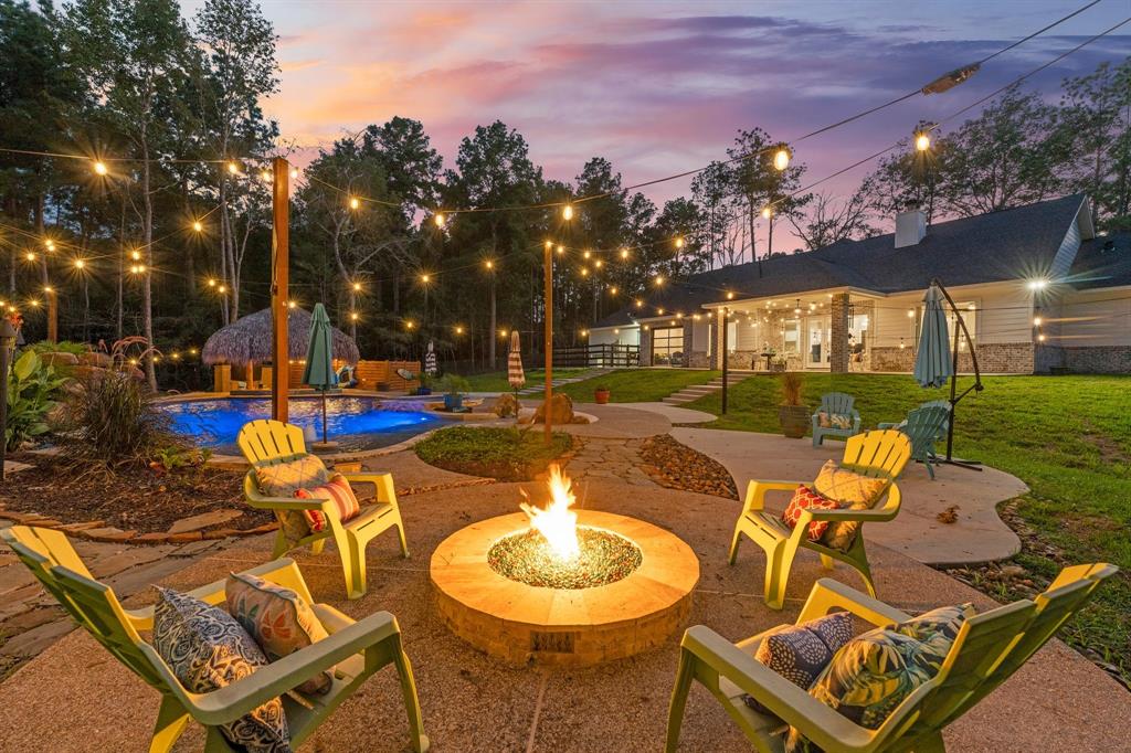 a view of a swimming pool with a patio and a yard