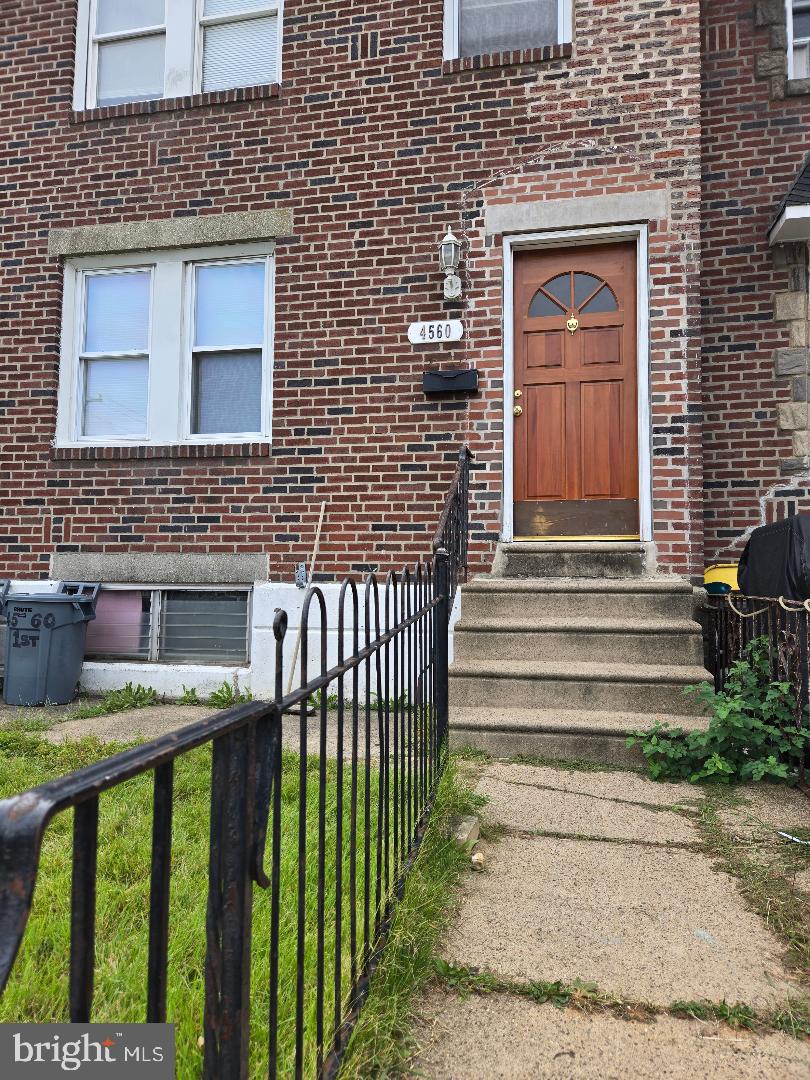 a front view of a house with stairs