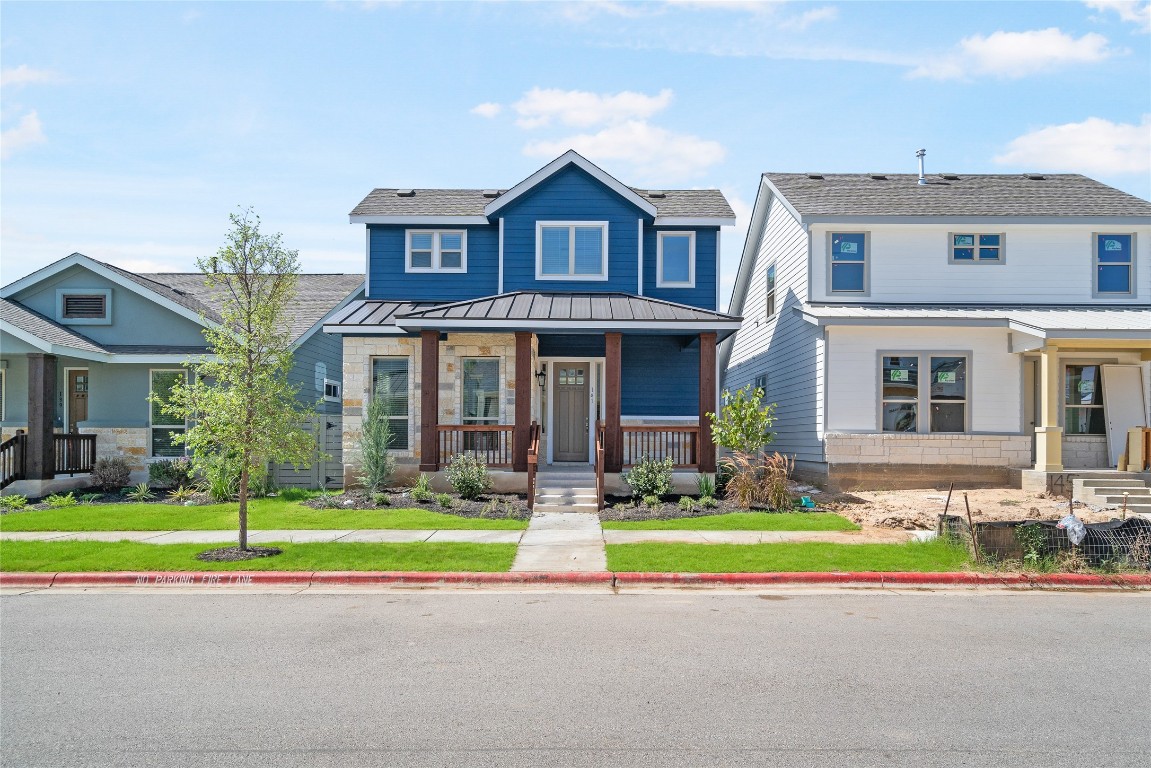 a front view of a house with a yard and a garage